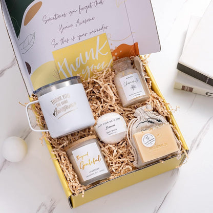 Open view of self-care box showing candle, soap, matches, and lotion